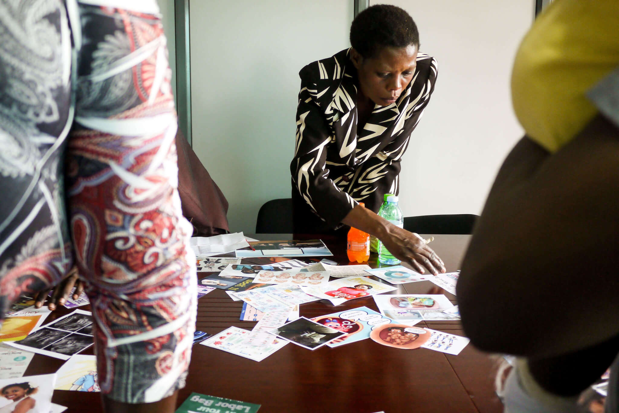 Women taking part in a Better Outcomes in Labour Difficulty workshop, sorting cards to share their pregnancy journey.