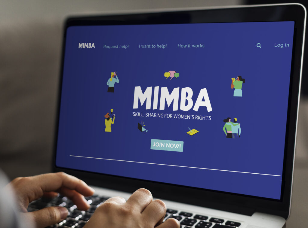 Person looking at a laptop screen which has MIMBA front page open.