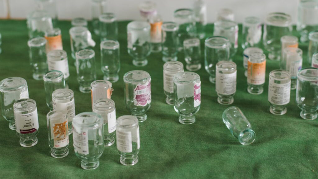 Images as data captures the lived realities in healthcare facilities across the globe. Empty medicine vials on a table.